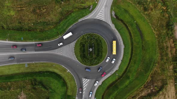 Cars Drive Along Large Circular Crossroad in Rural Area alt