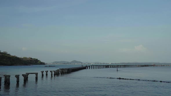 panning shot of broken wooden bridge to the sea (damage from storm) at Rayong,Thailand