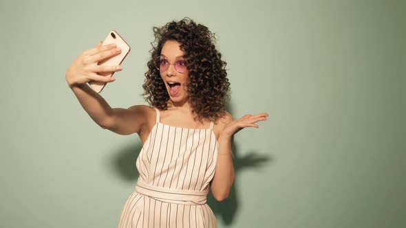 Beautiful smiling model with afro curls hairstyle dressed in hipster clothes alt