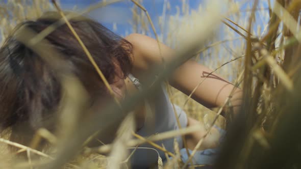 Skill Woman with Short Hair Wearing Bodysuit Relaxing on the Wheat Field alt