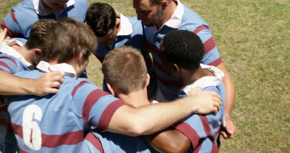 Rugby players forming a huddle on the field 4K 4k alt