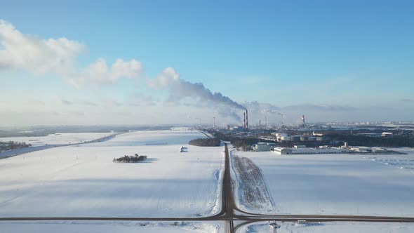 Smoke from the pipes of a chemical enterprise top view. Panorama of the factory in winter.