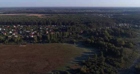 Drone Aerial View Small Village Between Forest and Field at Sunrise alt