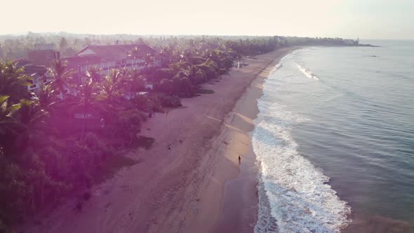 Ocean coast at dawn. Blue water, waves and beautiful beach. alt