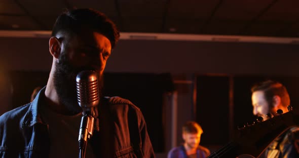 Band performing in studio alt