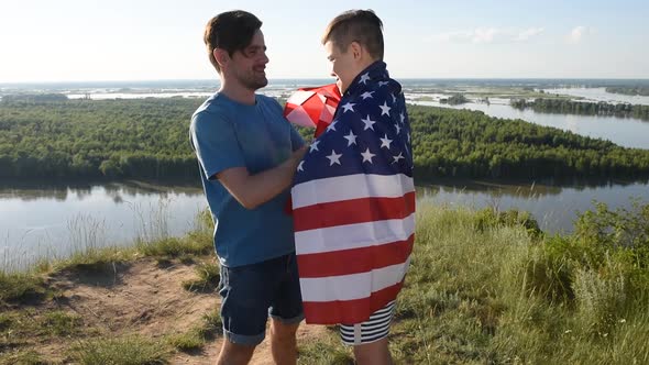 Cute Young Boy and His Father Holding Aloft the American Flag