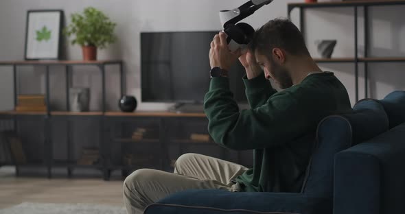 Man Is Wearing Vr Goggles at First Time Immersing Into Virtual World and Amazing Looking Around alt