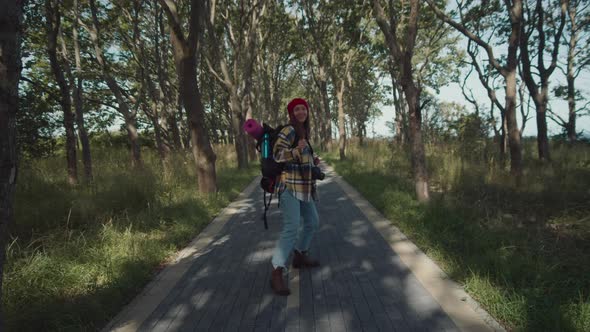 Female hiker enjoy hitchhike in summer forest