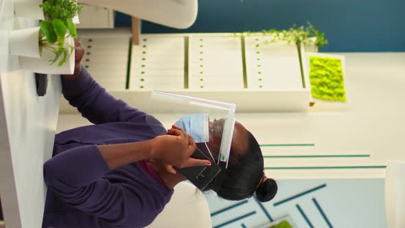 Vertical Video African Entrepreneur with Protective Mask Speaking on Phone alt