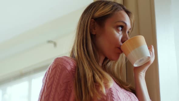 Thoughtful woman having coffee 4k alt
