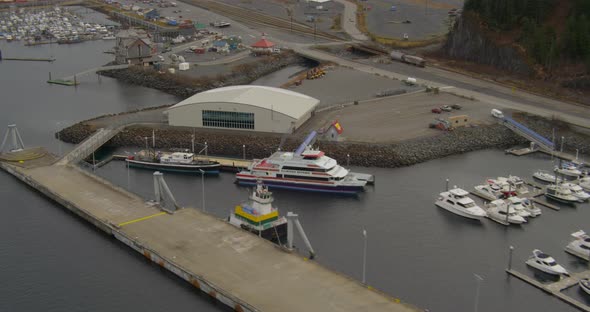 Aerial overhead of Troopers helicopter flying over glacier towards iceberg, drone alt