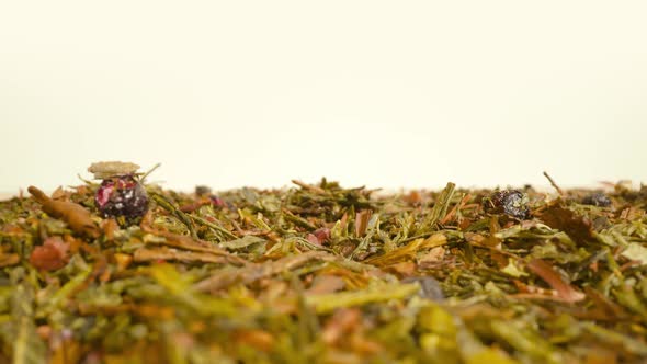Green Tea Leaves Scattered on the Table alt