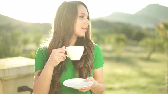 Woman Smiling and Drinking Coffee
