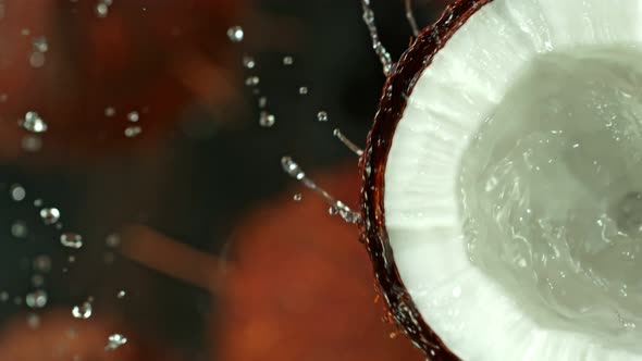 Super Slow Motion Shot of Splashing Water From Coconut at 1000Fps. alt