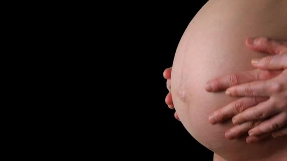 HD - Pregnant woman. hands of the man and the woman stroke the belly alt