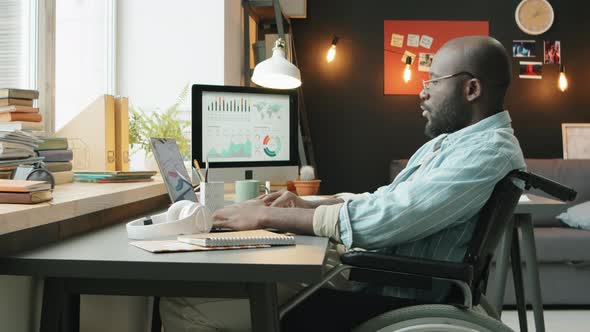 African American Man with Disability Working from Home alt