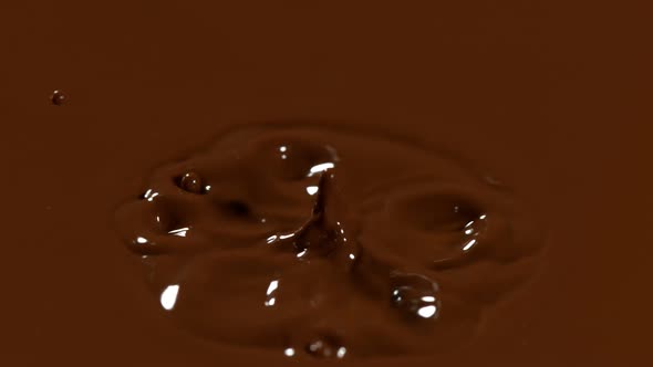 Super Slow Motion Detail Shot of Chocolate Liquid Drop at 1000 Fps alt