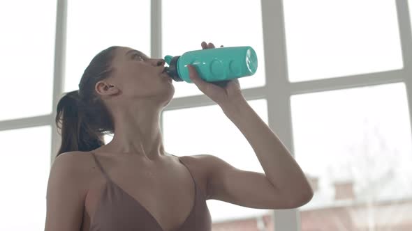 Sportswoman Making Water Sip alt