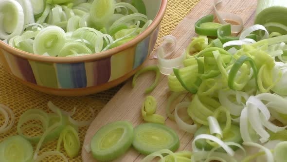 Chopped raw organic leek on a wooden cutting board