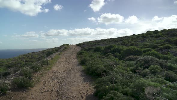 Sun Shining on Empty Path that Lead Through Outskirsts of Gozo Island