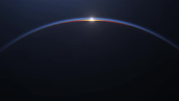 Sunrise over the Earth. View from space. The planet rotates towards the sun.