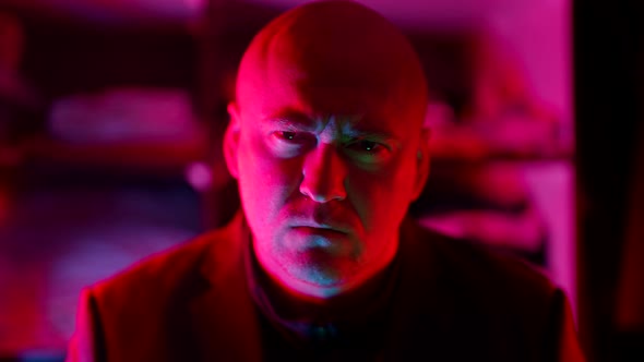 Serious Angry Man in Neon Light in Darkness Prohibiting Wagging Finger and Beckoning alt