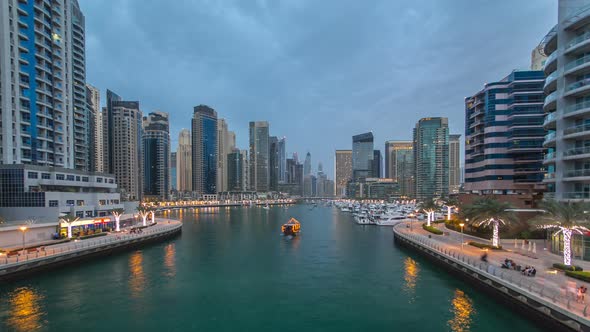 View of Dubai Marina Towers and Canal in Dubai Day to Night Timelapse alt