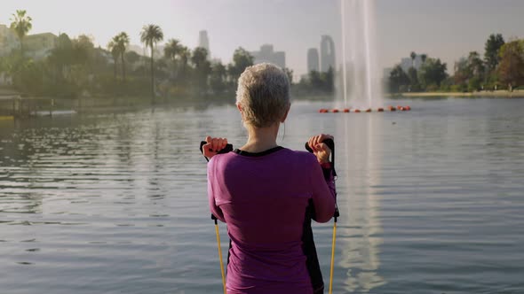 Senior Woman Working Out In The Park alt