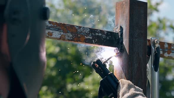 Slow Motion Close View Welder Connects Metal Parts of Fence alt