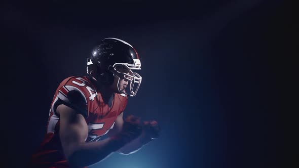 Portrait of Determined Professional American Football Player in Helmet in Bright Stadium alt