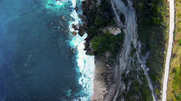 Top down view on hidden sandy beach with azure water alt
