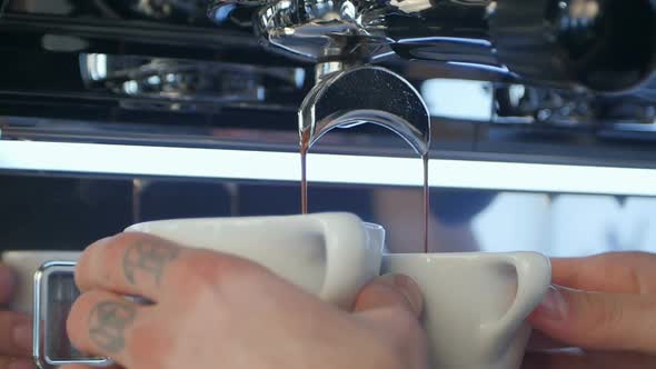 Professional Espresso Machine Pouring Strong Looking Fresh Coffee Into a Neat Ceramic Cup alt