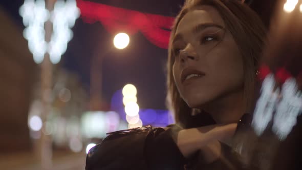 Young Pretty Girl in Car Leans Out Passenger Side Car Window Wind Stirs Her Hair She Looks at the alt