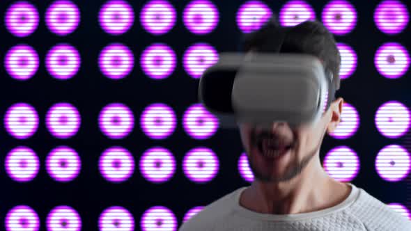 Man with Virtual Reality Glasses Dances Vigorously to Music and Sings