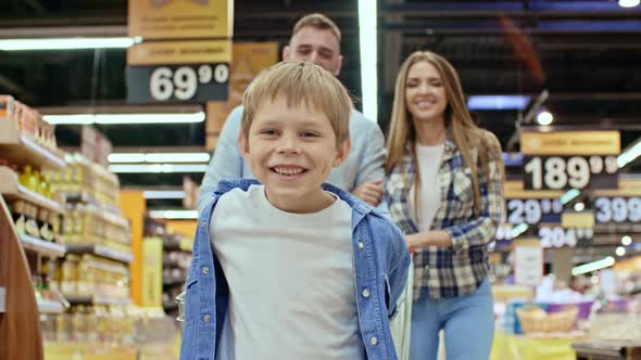 Happy Kid Enjoying Shopping with Parents, Stock Footage | VideoHive