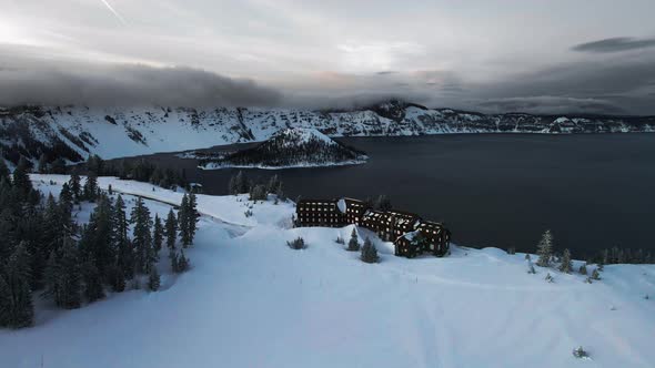 Aerial footage of wooden chalet on the shore of Crater Lake, Oregon, USA alt