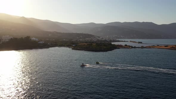 Aerial View of a Motor Boat Towing a Tube. Elounda, Crete, Greece