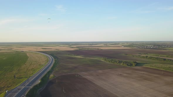 Aerial Footage of a Man Paragliding with Motor