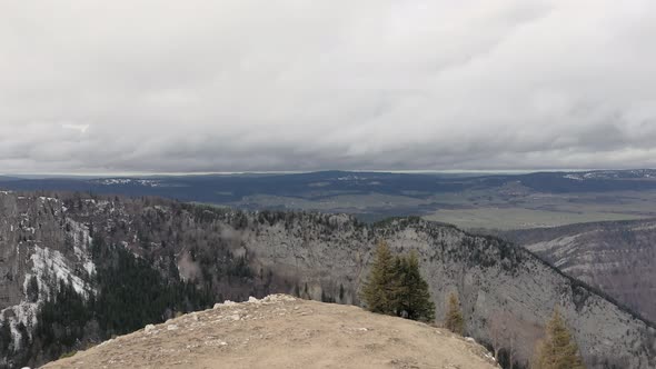 aerial drone of beautiful mountains in Creux Du Van, Neuchatel, Switzerland. from the ground to up s alt