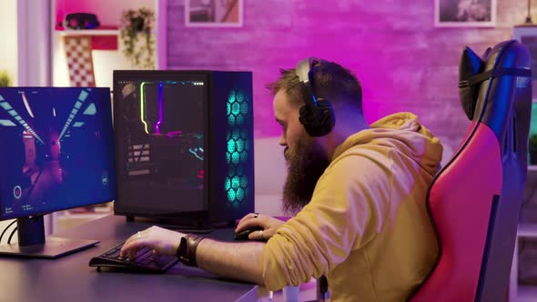 Focused Young Man Sitting on Gaming Chair alt