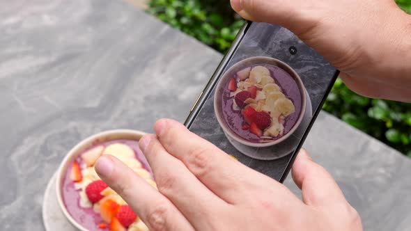 Male Hands Making Photos of Healthy Food for Social Media on Modern Smartphone alt
