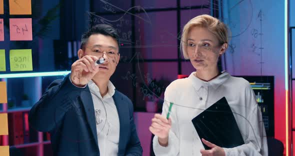 Workmates Brainstorming New Ideas in Business Project, Learning Charts on Glass Board alt