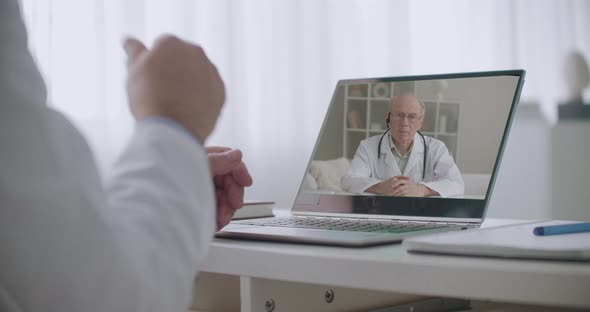 Videochat of Two Doctors in Offices of Hospitals, Consultation of Medical Colleagues, Modern alt
