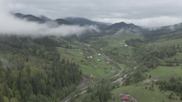 Ukraine, Carpathian Mountains: Village in the Mountains. Aerial, Flat, Gray alt