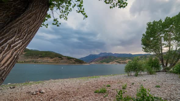 Time lapse viewing lake at sunset as clouds move through the sky alt