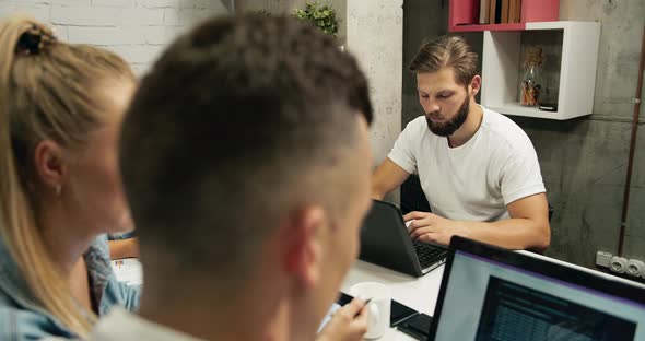 Team Working on Laptops in Loft Office