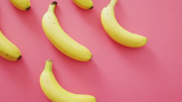 Video of fresh bananas with copy space on pink background alt