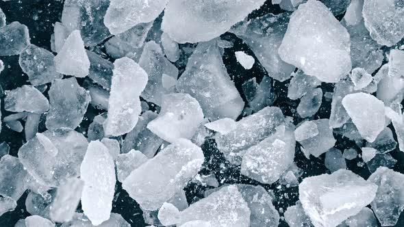 Super Slow Motion Shot of Falling and Shattering Crushed Ice on Black Background at 1000Fps alt