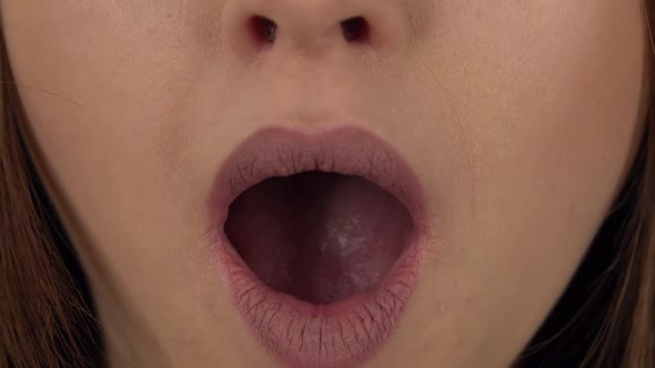 Woman Lips with the Wow Emotion of Surprise on a Green Screen. Close Up alt