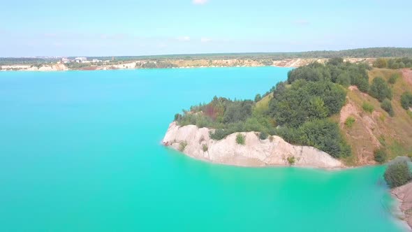 An artificial lake in chalk quarry. view from drone. Turquoise water background alt